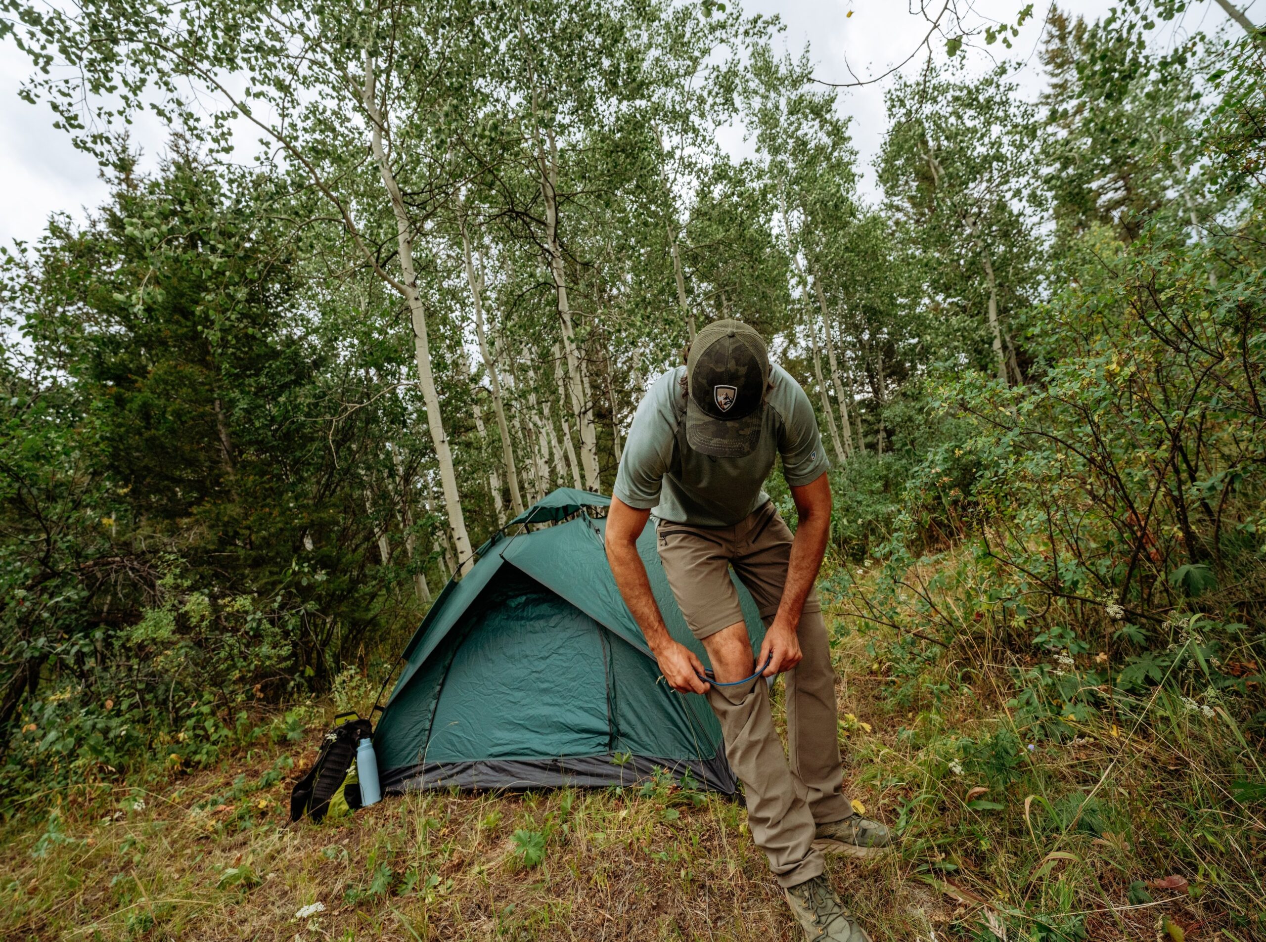 KรHL Renegade convertible hiking pants being converted to shorts outdoors