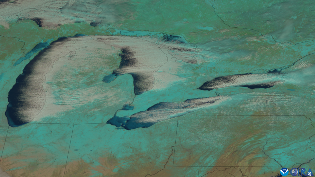Satellite view of lake-effect cloud bands streaming off the Great Lakes.